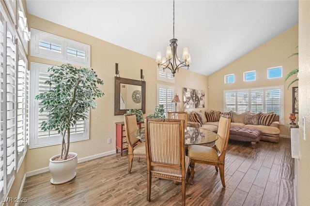 3295 Cooper Creek Dr, Henderson, NV 89074 - dining room with a chandelier, wood finished floors, and a healthy amount of sunlight