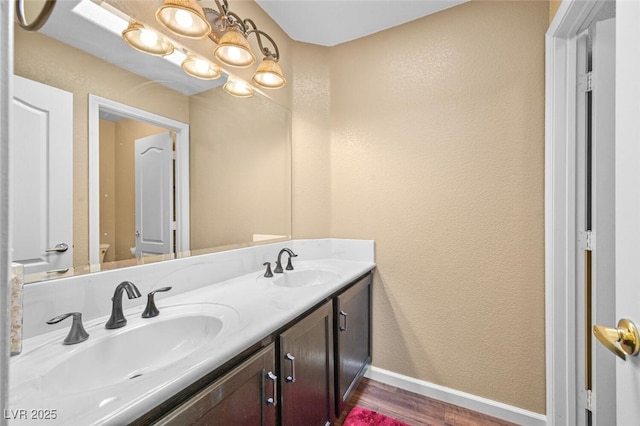 3295 Cooper Creek Dr, Henderson, NV 89074 - bathroom featuring a sink, a textured wall, and wood finished floors