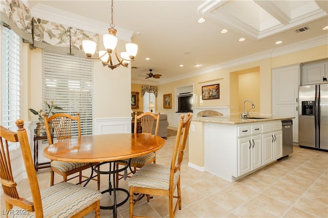 dining area with recessed lighting, wainscoting, light tile patterned floors, ceiling fan with notable chandelier, and crown molding