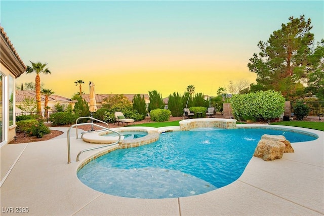 view of swimming pool featuring a patio, fence, and a pool with connected hot tub