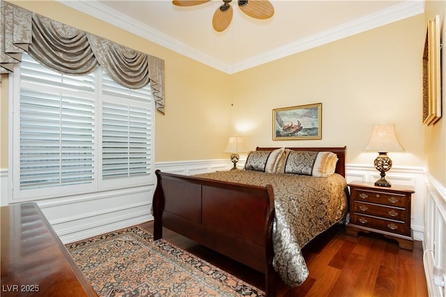 bedroom featuring ornamental molding, wainscoting, a decorative wall, and dark wood-type flooring