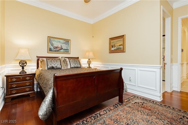 bedroom featuring a wainscoted wall, ornamental molding, and dark wood-style floors