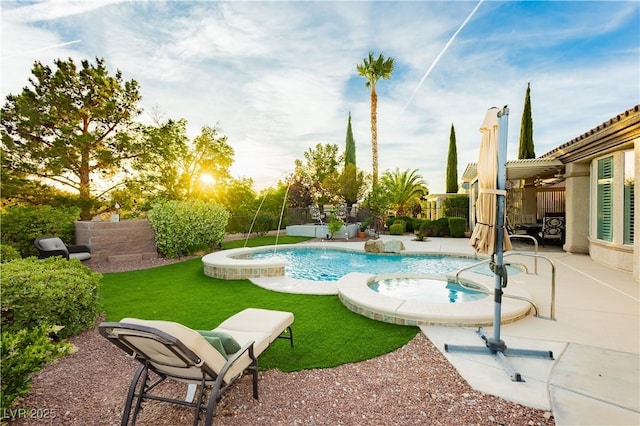 view of pool with a pool with connected hot tub, a patio, and a fenced backyard