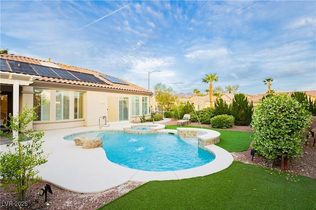 view of pool with a lawn, a patio area, and a pool with connected hot tub