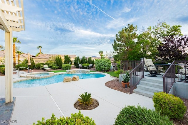 view of swimming pool featuring a patio and a pool with connected hot tub