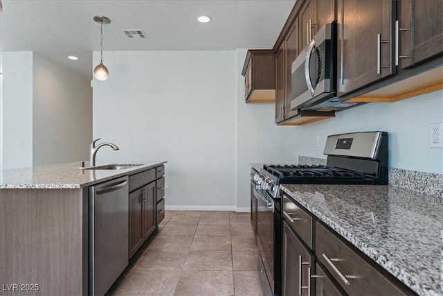 kitchen featuring appliances with stainless steel finishes, a sink, dark brown cabinets, and recessed lighting