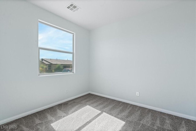 unfurnished room featuring carpet floors and baseboards
