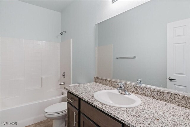 bathroom featuring toilet, vanity, and bathing tub / shower combination