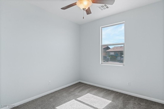 carpeted empty room featuring ceiling fan and baseboards
