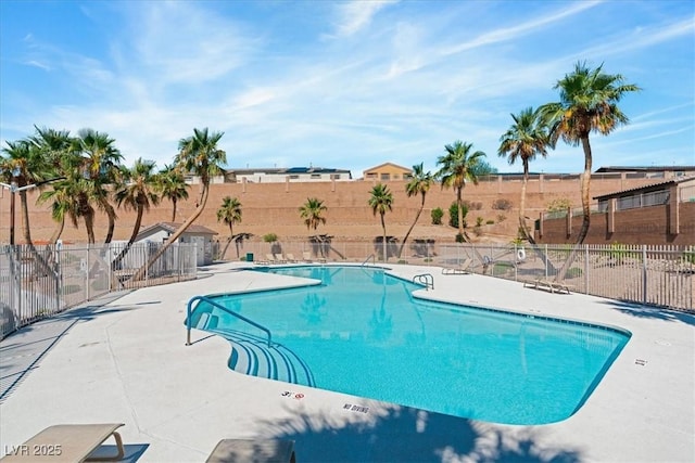 community pool featuring a patio and fence