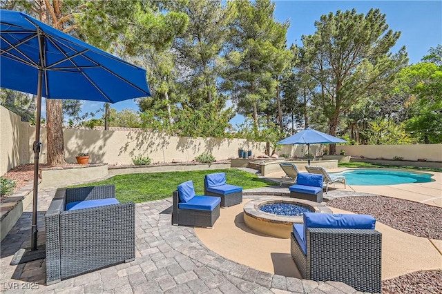 view of patio featuring a fenced backyard and an outdoor living space with a fire pit