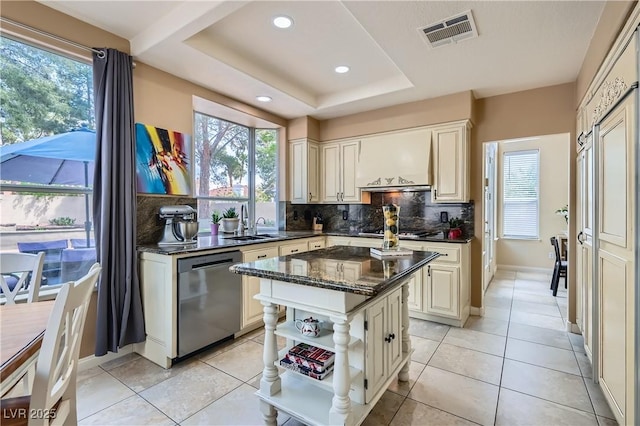 kitchen with dishwasher, decorative backsplash, a center island, open shelves, and dark stone counters