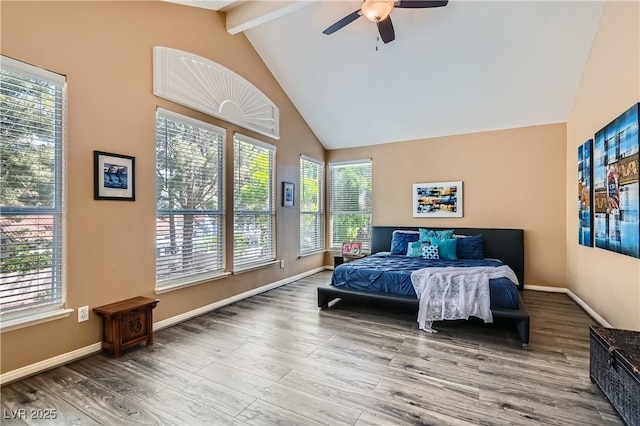 bedroom featuring high vaulted ceiling, wood finished floors, beamed ceiling, baseboards, and a tiled fireplace