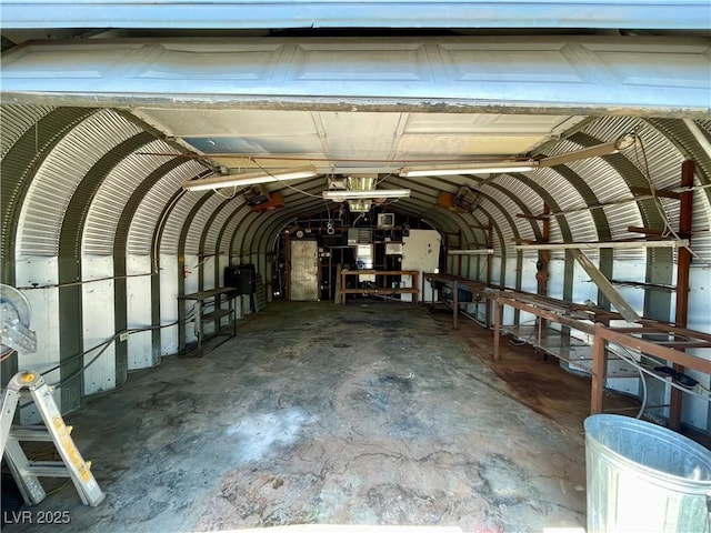 4682 Tamalpias Ave, Las Vegas, NV 89120 - miscellaneous room featuring vaulted ceiling, unfinished concrete floors, and a garage