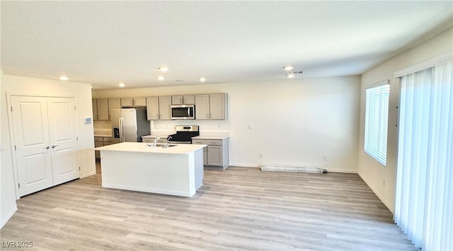 3402 La Cura Ave Lot 69, Las Vegas, NV 89141 - kitchen with stainless steel appliances, gray cabinets, a sink, recessed lighting, and light wood-type flooring