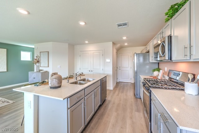 3402 La Cura Ave Lot 69, Las Vegas, NV 89141 - kitchen with appliances with stainless steel finishes, a sink, light wood finished floors, an island with sink, and recessed lighting