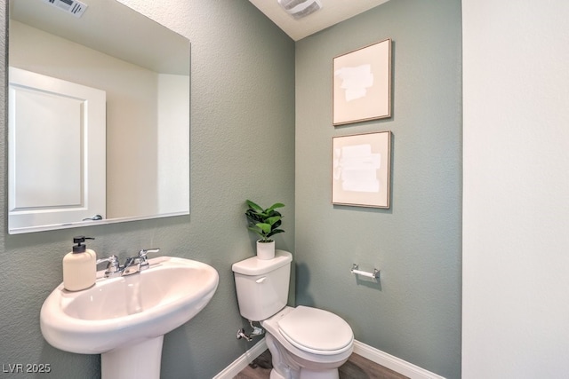 3402 La Cura Ave Lot 69, Las Vegas, NV 89141 - bathroom featuring a sink, toilet, wood finished floors, and baseboards