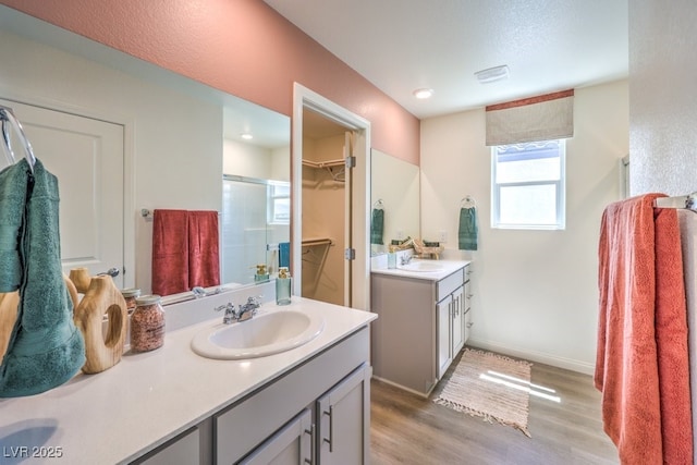 3402 La Cura Ave Lot 69, Las Vegas, NV 89141 - full bath with a shower stall, wood finished floors, two vanities, baseboards, and a walk in closet