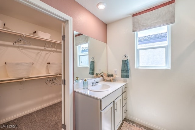 3402 La Cura Ave Lot 69, Las Vegas, NV 89141 - bathroom with a walk in closet, vanity, and baseboards