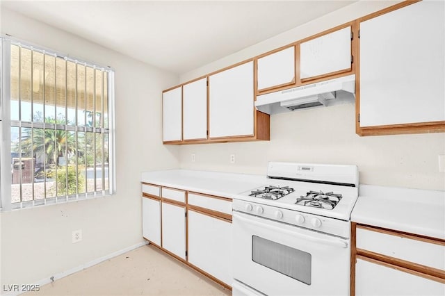 719 Roberta Alecia Ave, North Las Vegas, NV 89031 - kitchen featuring gas range gas stove, under cabinet range hood, light countertops, and baseboards