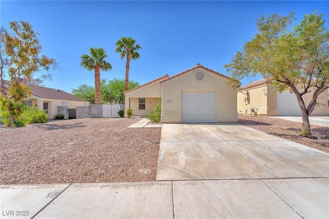 719 Roberta Alecia Ave, North Las Vegas, NV 89031 - mediterranean / spanish house featuring stucco siding, driveway, a garage, and a tile roof