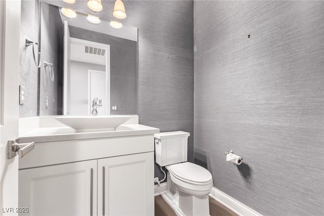 8797 Pinley Spring St, Las Vegas, NV 89113 - bathroom featuring vanity, toilet, and wood finished floors