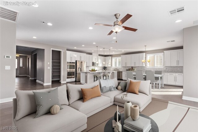 8797 Pinley Spring St, Las Vegas, NV 89113 - living area featuring a ceiling fan, recessed lighting, baseboards, and dark wood-style flooring