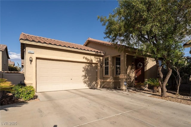 view of front facade featuring a garage, stucco siding, driveway, and a tile roof
