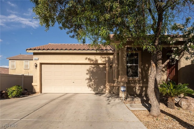 view of front of house featuring fence, an attached garage, stucco siding, concrete driveway, and a tiled roof