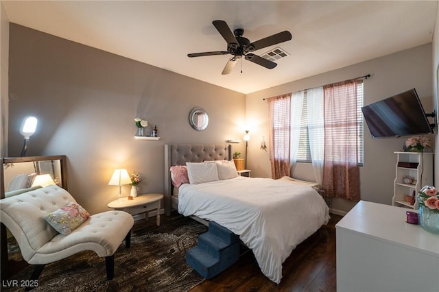 bedroom with visible vents, dark wood-style flooring, and ceiling fan