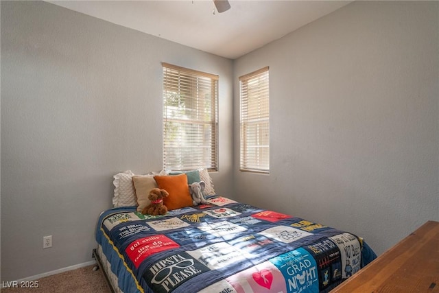 bedroom featuring carpet floors, baseboards, and a ceiling fan