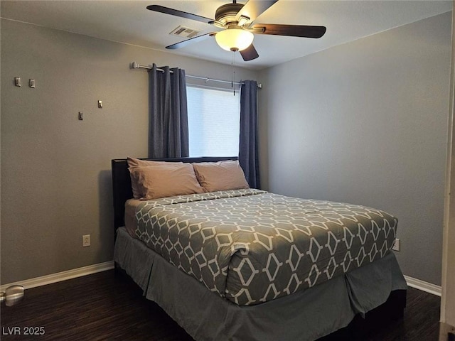 bedroom with dark wood-style flooring, visible vents, a ceiling fan, and baseboards