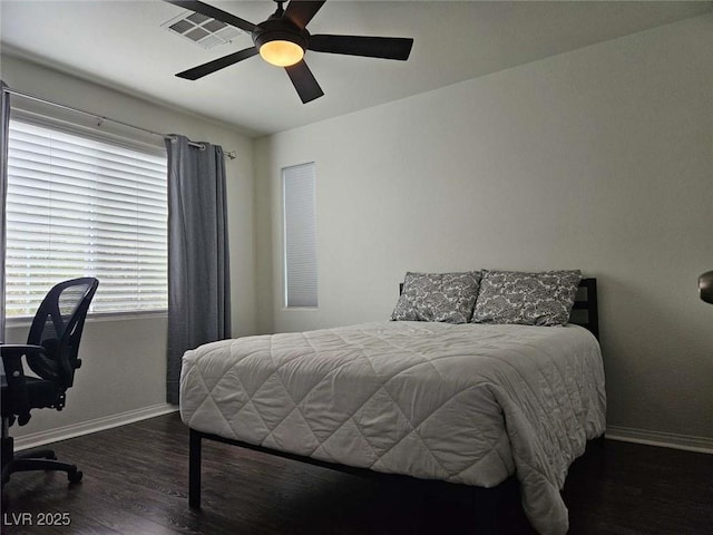 bedroom with wood finished floors, visible vents, ceiling fan, and baseboards