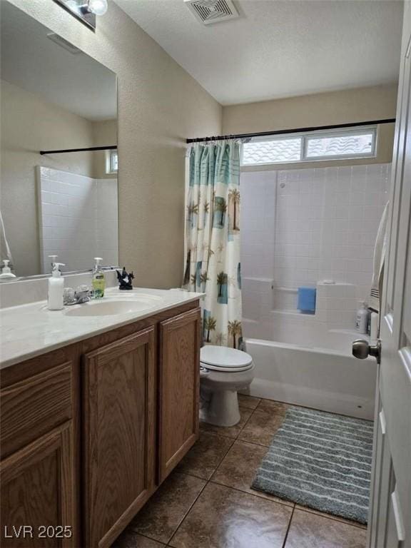 bathroom featuring visible vents, shower / bath combo with shower curtain, toilet, vanity, and tile patterned flooring