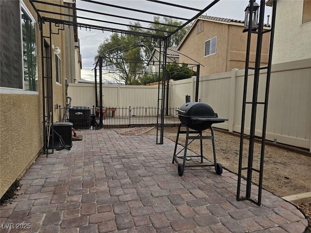 view of patio / terrace featuring cooling unit and a fenced backyard