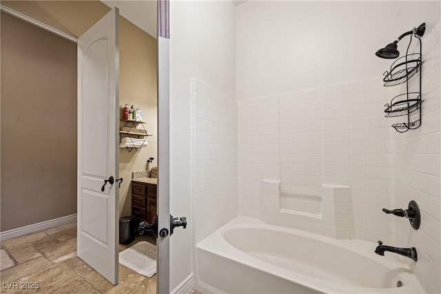 1981 Trophy Elk Ave, Logandale, NV 89021 - bathroom with stone tile floors, bathtub / shower combination, and baseboards