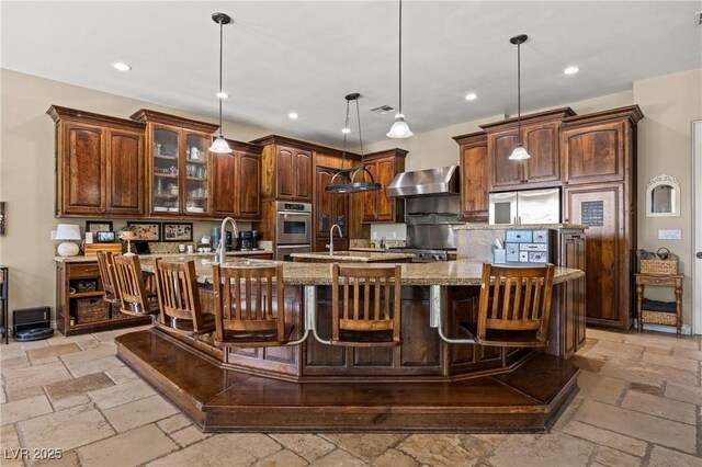 1981 Trophy Elk Ave, Logandale, NV 89021 - kitchen featuring stone tile floors, a spacious island, wall chimney range hood, and a sink
