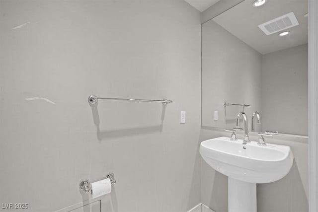 bathroom featuring a sink and visible vents