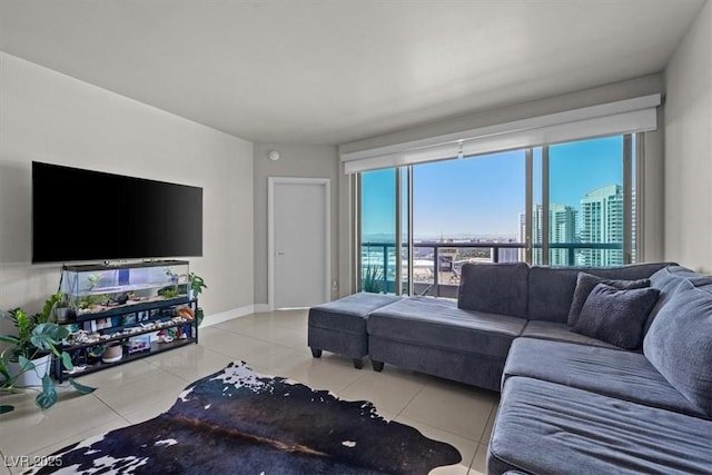 living room with a view of city, light tile patterned flooring, and baseboards