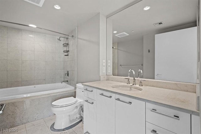 bathroom featuring tile patterned floors, recessed lighting, tiled shower / bath, and toilet