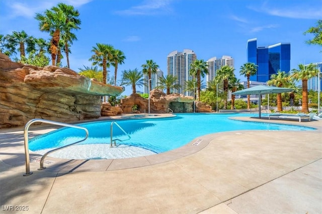 pool with a city view and a patio area