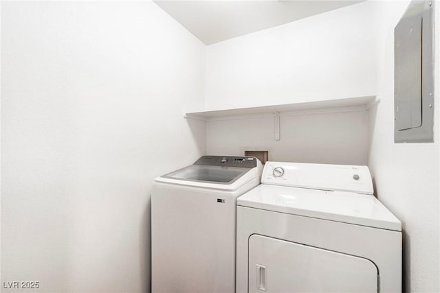washroom with electric panel, laundry area, and washing machine and clothes dryer