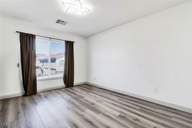 unfurnished room with visible vents, baseboards, and light wood-type flooring