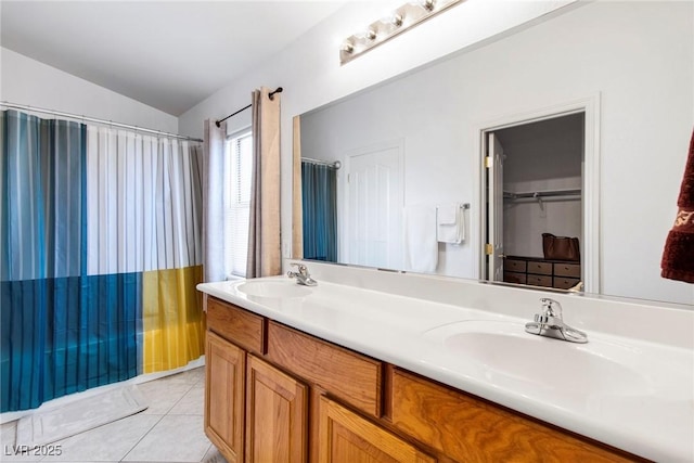 full bath with lofted ceiling, double vanity, tile patterned flooring, and a sink