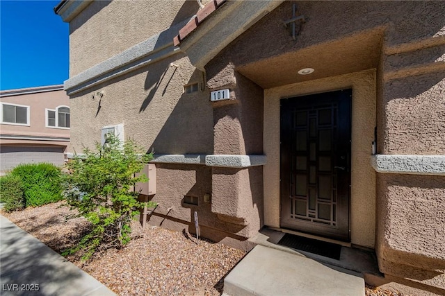 property entrance featuring stucco siding