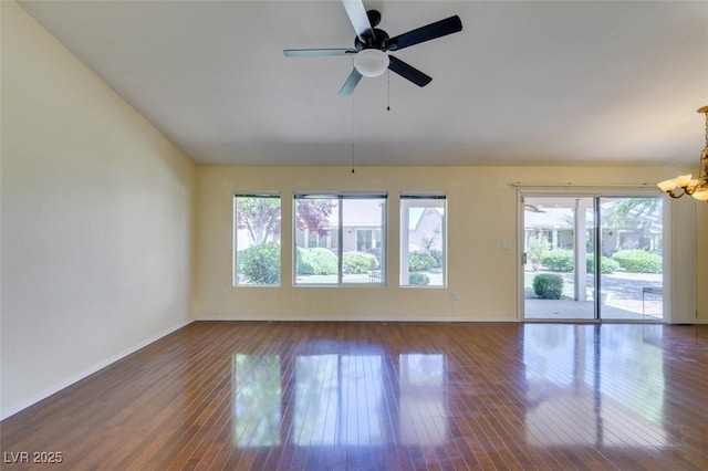 2078 Joy Creek Ln, Henderson, NV 89012 - unfurnished living room featuring wood-type flooring, ceiling fan with notable chandelier, and baseboards