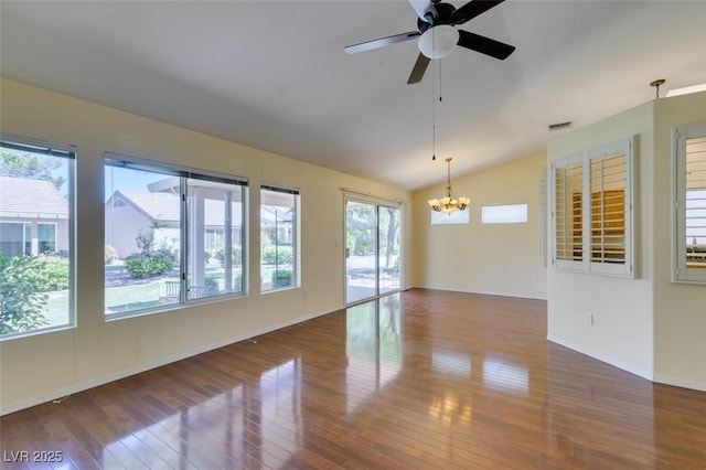 2078 Joy Creek Ln, Henderson, NV 89012 - spare room featuring visible vents, baseboards, wood-type flooring, vaulted ceiling, and ceiling fan with notable chandelier