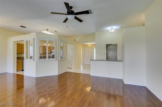 2078 Joy Creek Ln, Henderson, NV 89012 - unfurnished living room with visible vents, ceiling fan, baseboards, and light wood-style floors