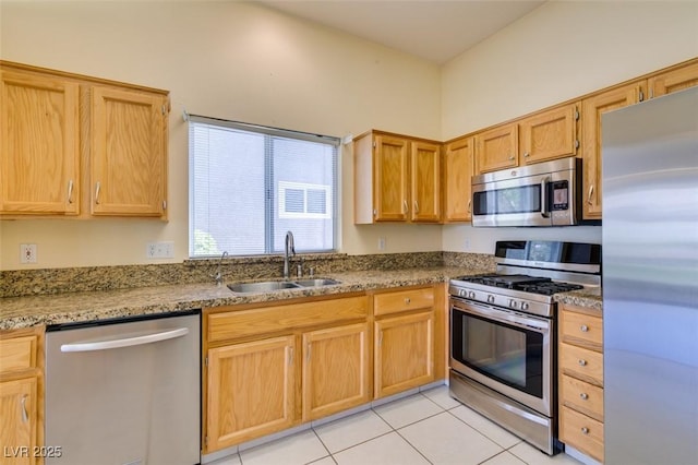 2078 Joy Creek Ln, Henderson, NV 89012 - kitchen with light tile patterned floors, stone countertops, a sink, and stainless steel appliances
