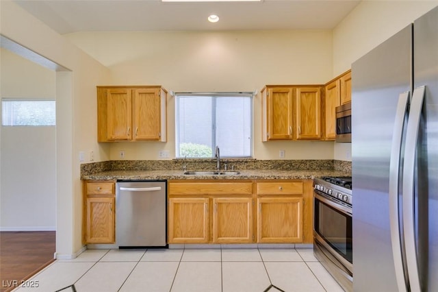 2078 Joy Creek Ln, Henderson, NV 89012 - kitchen featuring recessed lighting, a sink, light tile patterned flooring, dark stone countertops, and appliances with stainless steel finishes